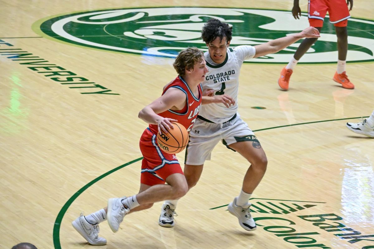 Jase Butler attempts to defend a University of New Mexico player in Colorado State University's home game against the Lobos Jan. 6. CSU lost 80-70.