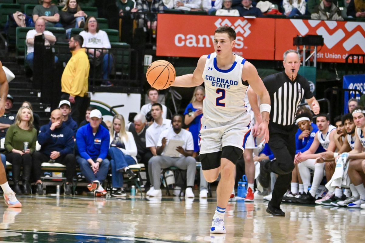 Brandon Rechsteiner looks to pass the ball to his teammates as he runs down the court in Colorado State University’s state pride game against UNLV Jan. 9. CSU won 70-62.
