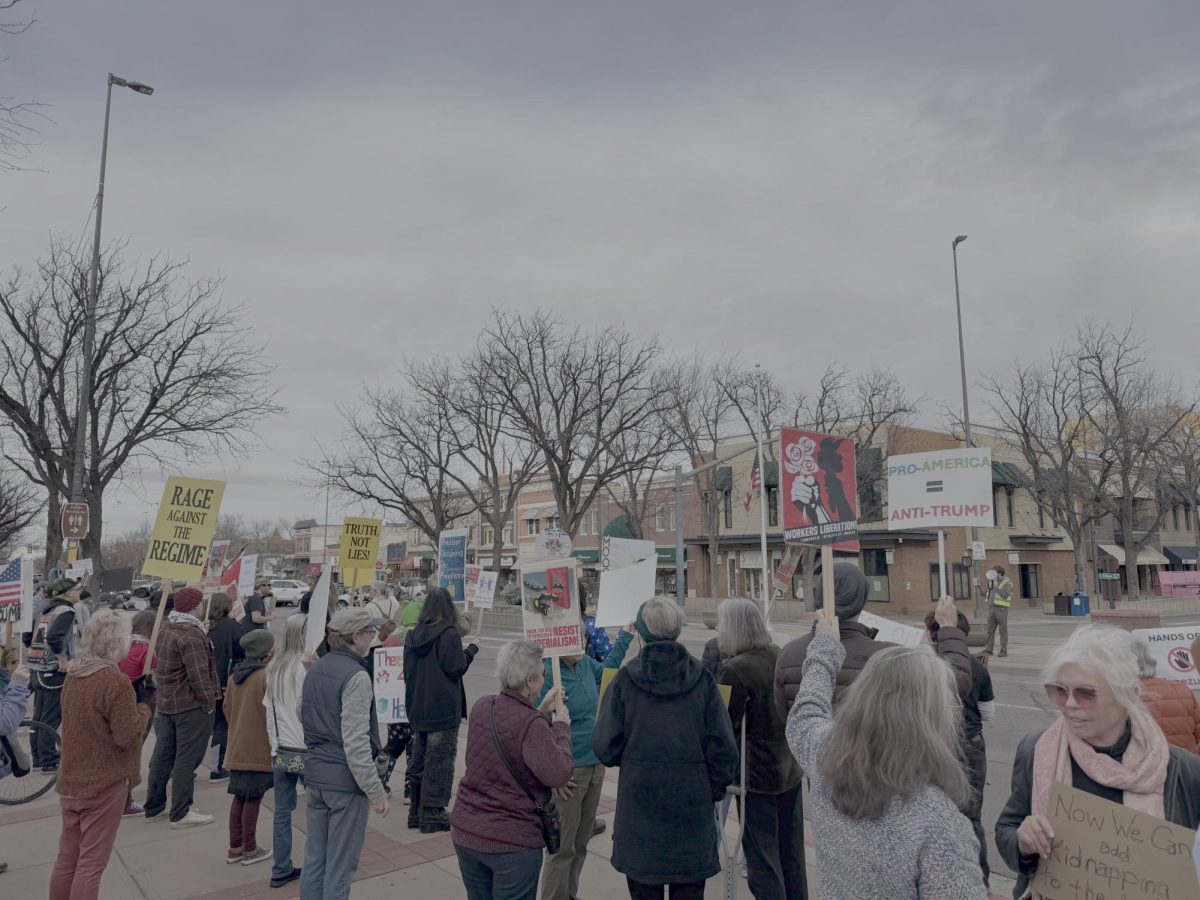 Fort Collins community members gather on College Avenue to protest the Jan. 3. U.S. operation in Venezuela, which resulted in the capture of President Nicolás Maduro and subsequent U.S. takeover of the Venezuelan government Jan. 4.