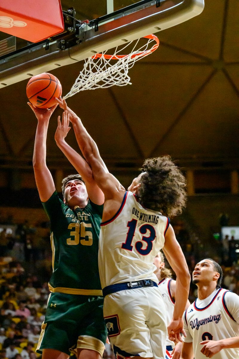 Colorado State University men's basketball forward Kyle Jorgensen goes up for a shot against University of Wyoming guard Adam Harakow in UW's Arena-Auditorium Jan. 31.