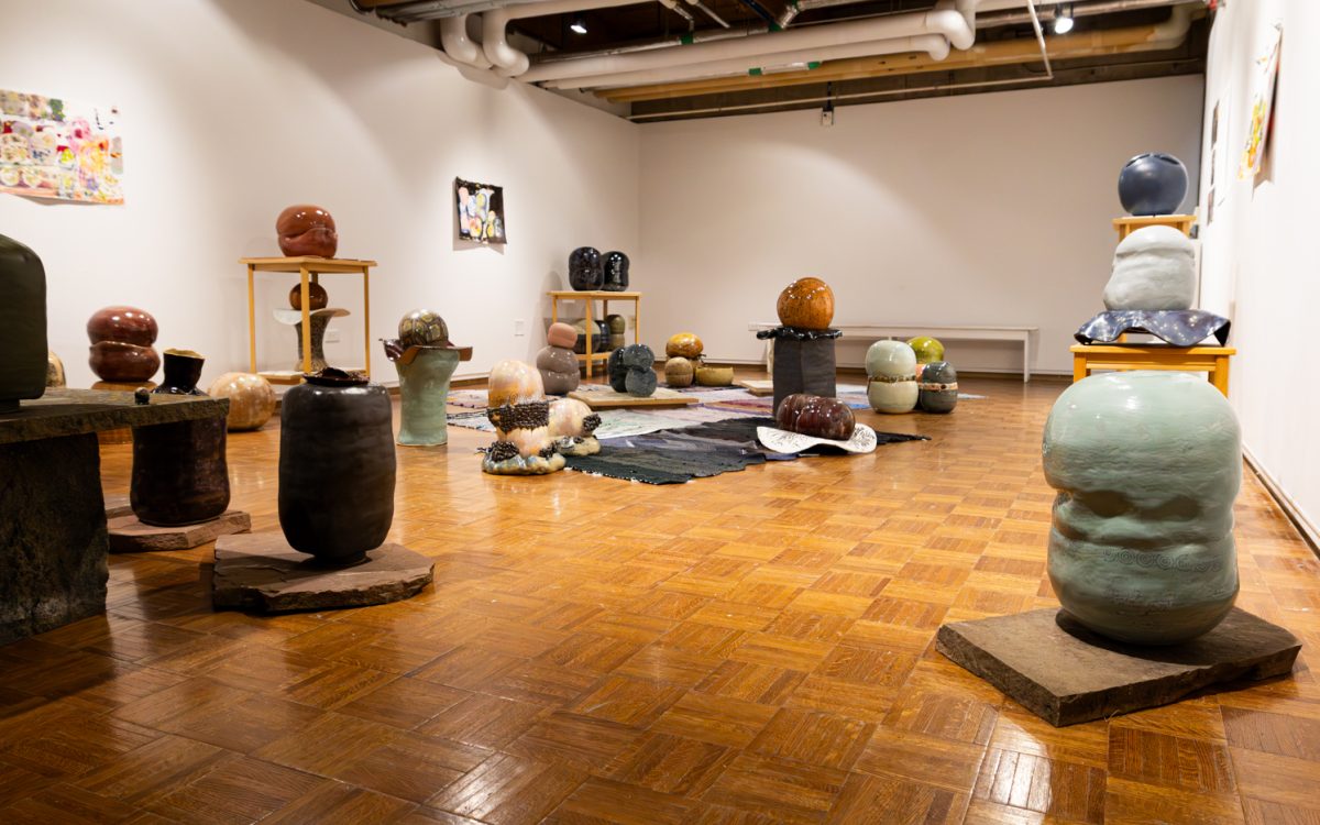 Ceramic sculptures in Susan Sternlieb's "A Neighborhood for Tough Times" exhibition are displayed on the floor of Colorado State University's Directions Gallery at the University Center for the Arts Feb. 9. The exhibition showcases a wide variety of ceramic sculptures that are carefully placed throughout the gallery to mimic a neighborhood. The exhibit is open until March 4. 