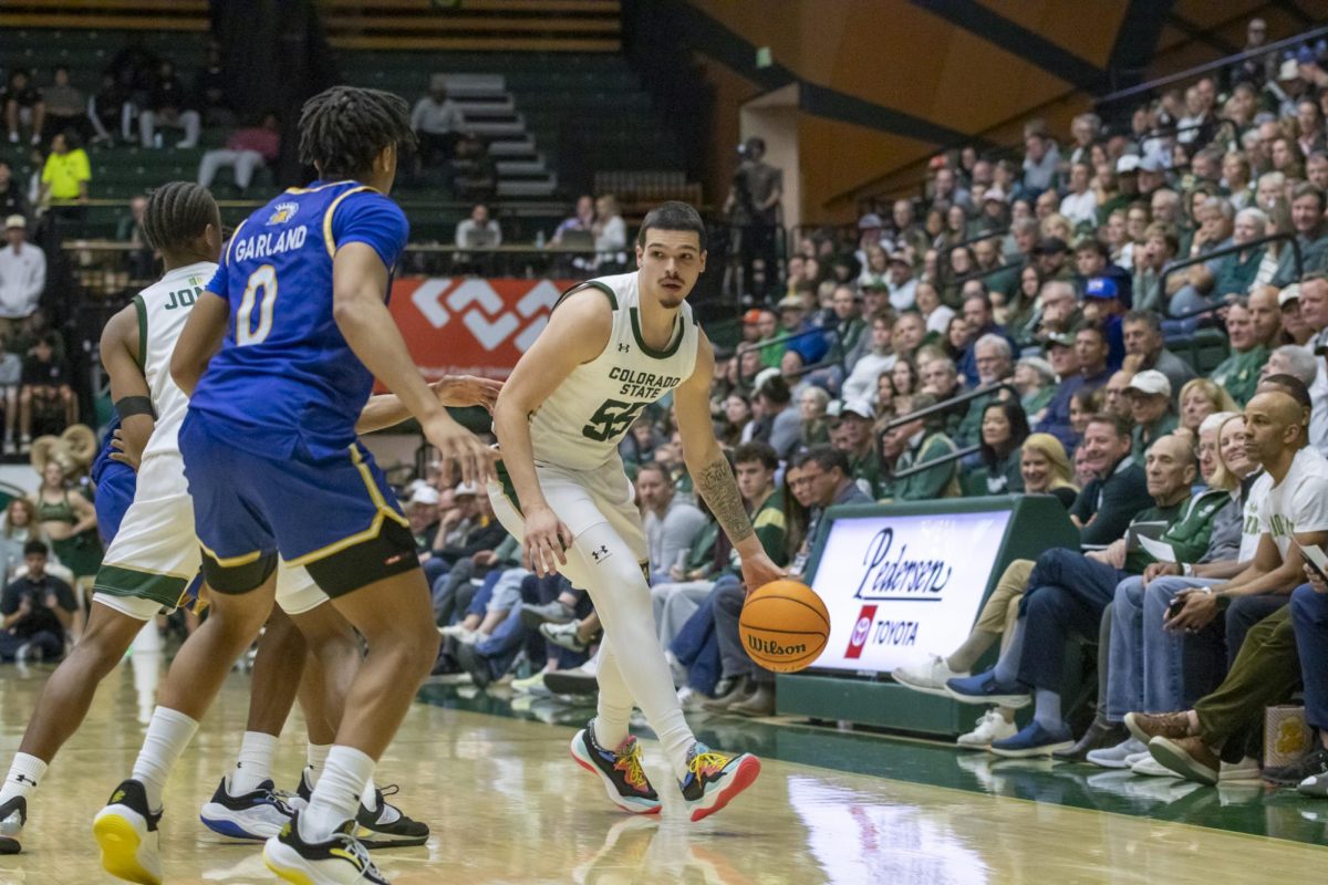 Colorado State University men's basketball Jevin Muniz (55) dribbles the ball during CSU's game against San Jose State University Feb. 7. Muniz put 15 points on the board for the Rams during the game.