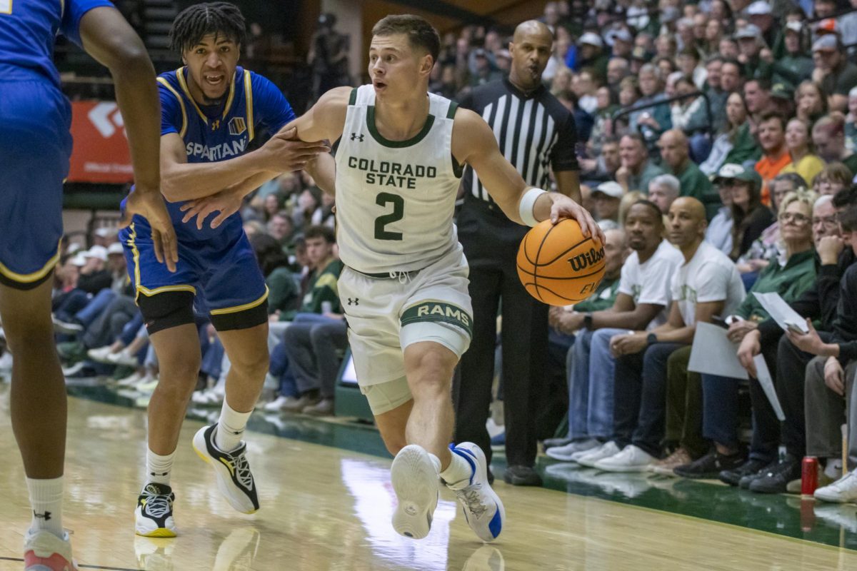 Colorado State University men's basketball guard Brandon Rechsteiner (2) dribbles the ball around a defender during the game against San Jose State University Feb. 7
