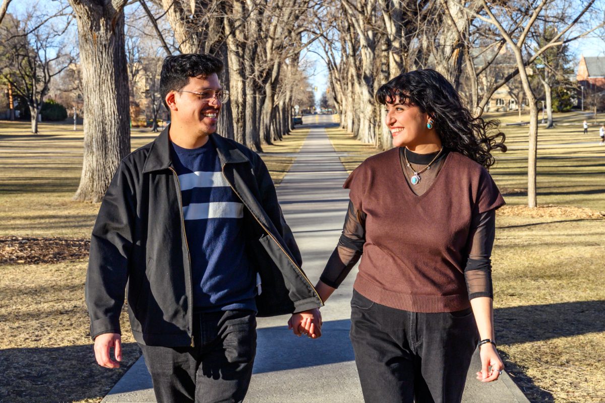 Colorado State University graduates Claudia Perez and Jesus Calderon smile at each other and walk down the CSU Oval Feb. 7. Perez and Calderon met at CSU in 2017, when Perez was a sophomore and Calderon was a junior, at the El Centro welcome back barbecue. "We love coming up to Fort Collins because it's very nostalgic,"  Perez said. "Especially since we met each other in the fall, we try to make the point of coming up here during that part of the year."
