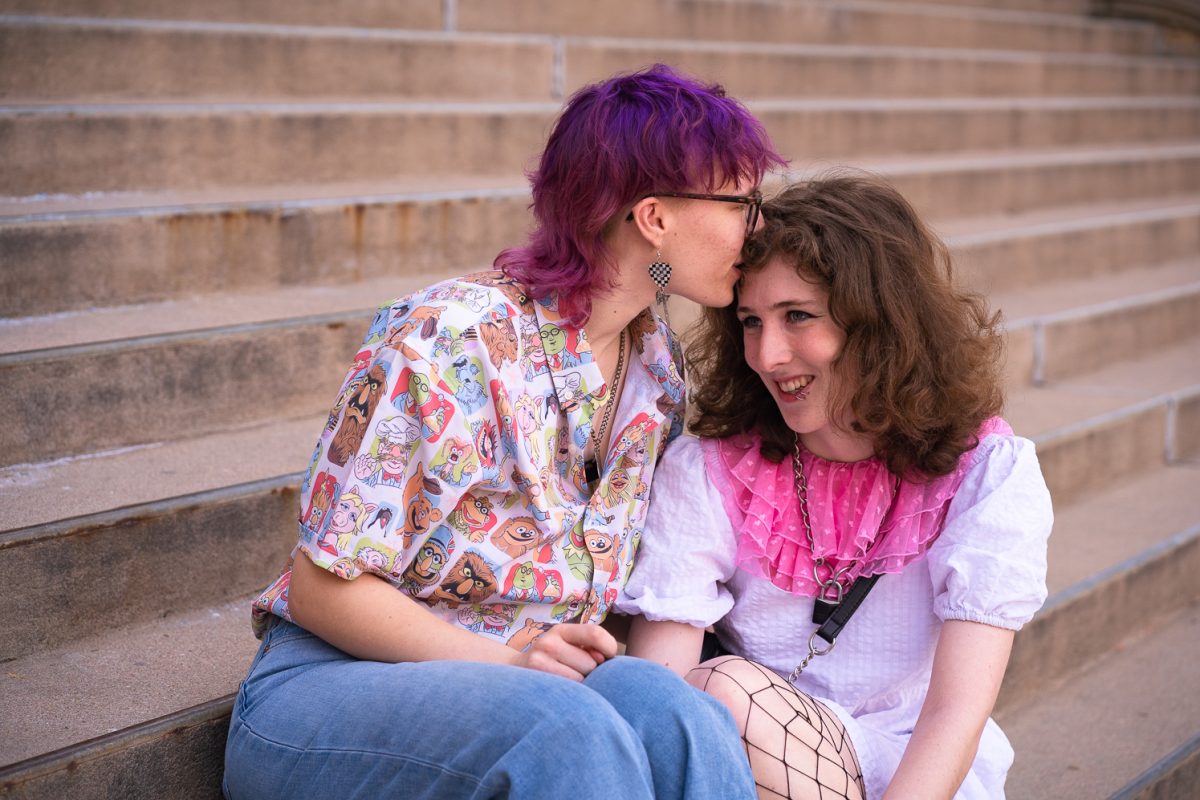 Ella Smith and Harper Paul sit on the steps of the Colorado State University Administration Building Sunday, Feb. 8. 