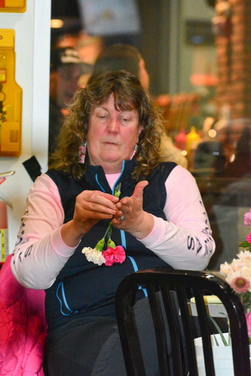 Christine Turner reflexing her flowers to make them appear larger and fuller for her arrangement Feb. 13. Christine attended this Galentines Floral Workshop with her friend Janet Mahoney. 