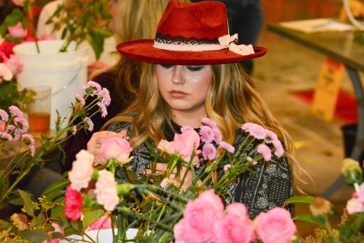 Brynn Bewalik working on her flower arrangement with her group of friends Feb. 13. This was the Galentines Floral Workshop put on by Breckenridge Brewery. 