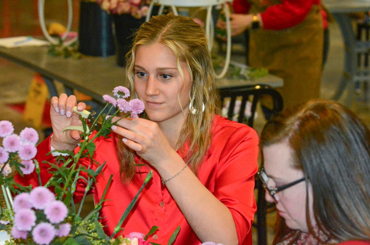 Janet Mahoney and Christine Turner talk while creating flower bouquets Feb. 13. The flower workshop was put on by Breckenridge Brewery. 