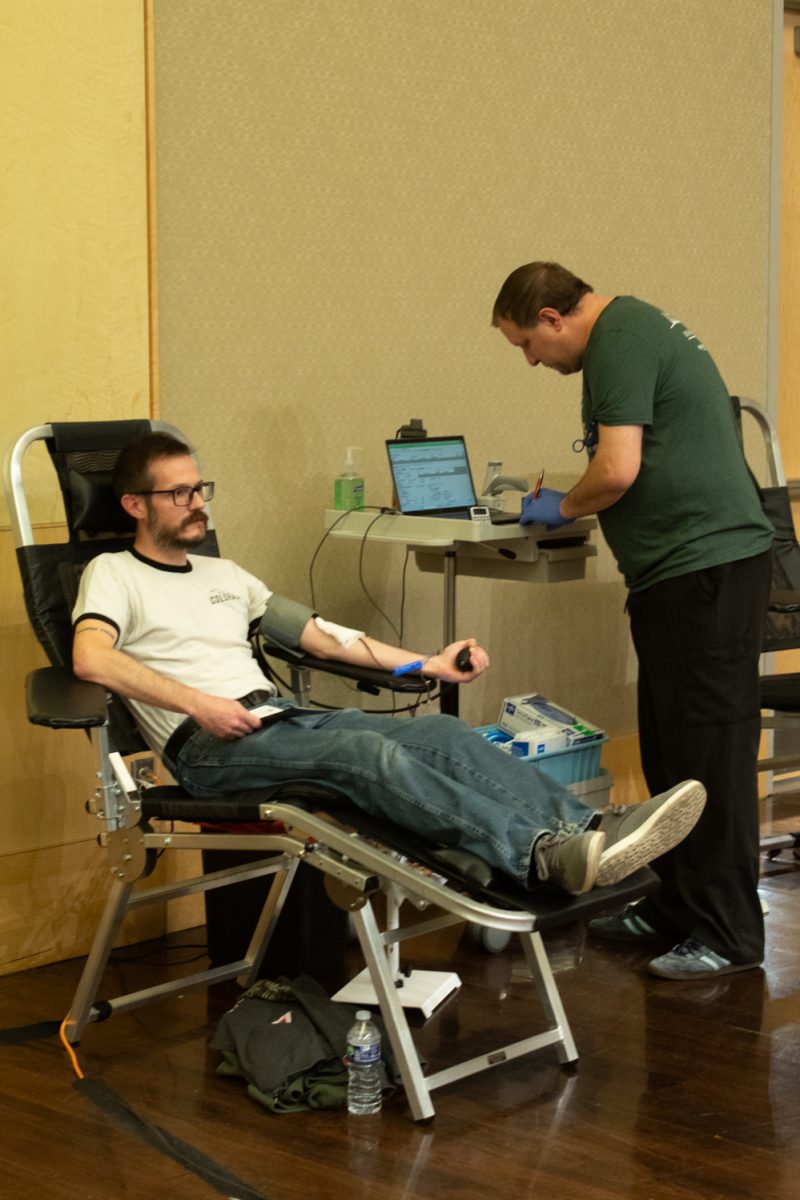 Chris Jeracki, a Colorado State University Student, squeezes a blood pressure cuff while donating blood during the Garth Englund Blood Center’s blood drive in the Lory Student Center Feb. 18.  “I’m just actually donating with my mom… we like to do things together. It’s a good cause," Jeracki said.