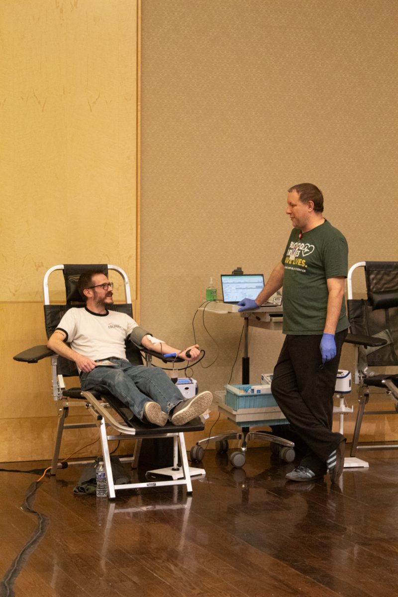Chris Jeracki a Colorado State University Student, squeezes a blood pressure cuff while donating blood and talking to Joe Dunn, blood drive coordinator for UCHealth, during the Garth Englund Blood Center’s blood drive, in the Lory Student Center, Feb. 18.“This is our first major blood drive with CSU, and it’s been our largest blood drive so far in the history of our blood center,” Dunn said.