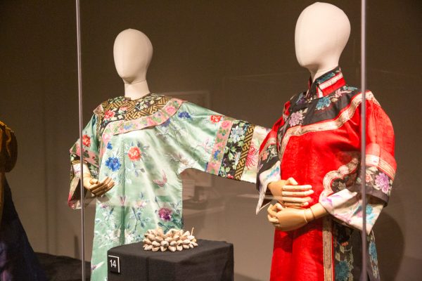 Two mannequins stand wearing silk robes.