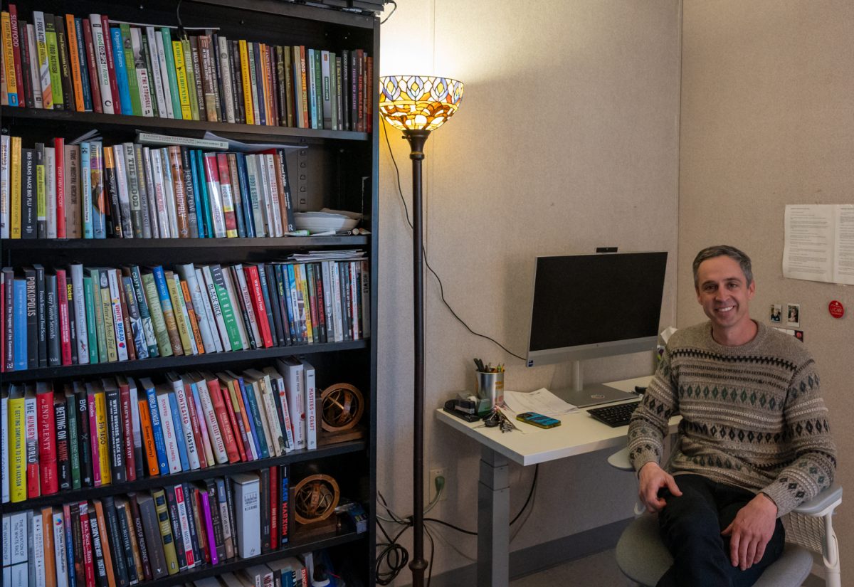 Joshua Sbicca, an associate professor of sociology at Colorado State University and director of the Prison Agriculture Lab, smiles for a portrait in his office Feb. 19.