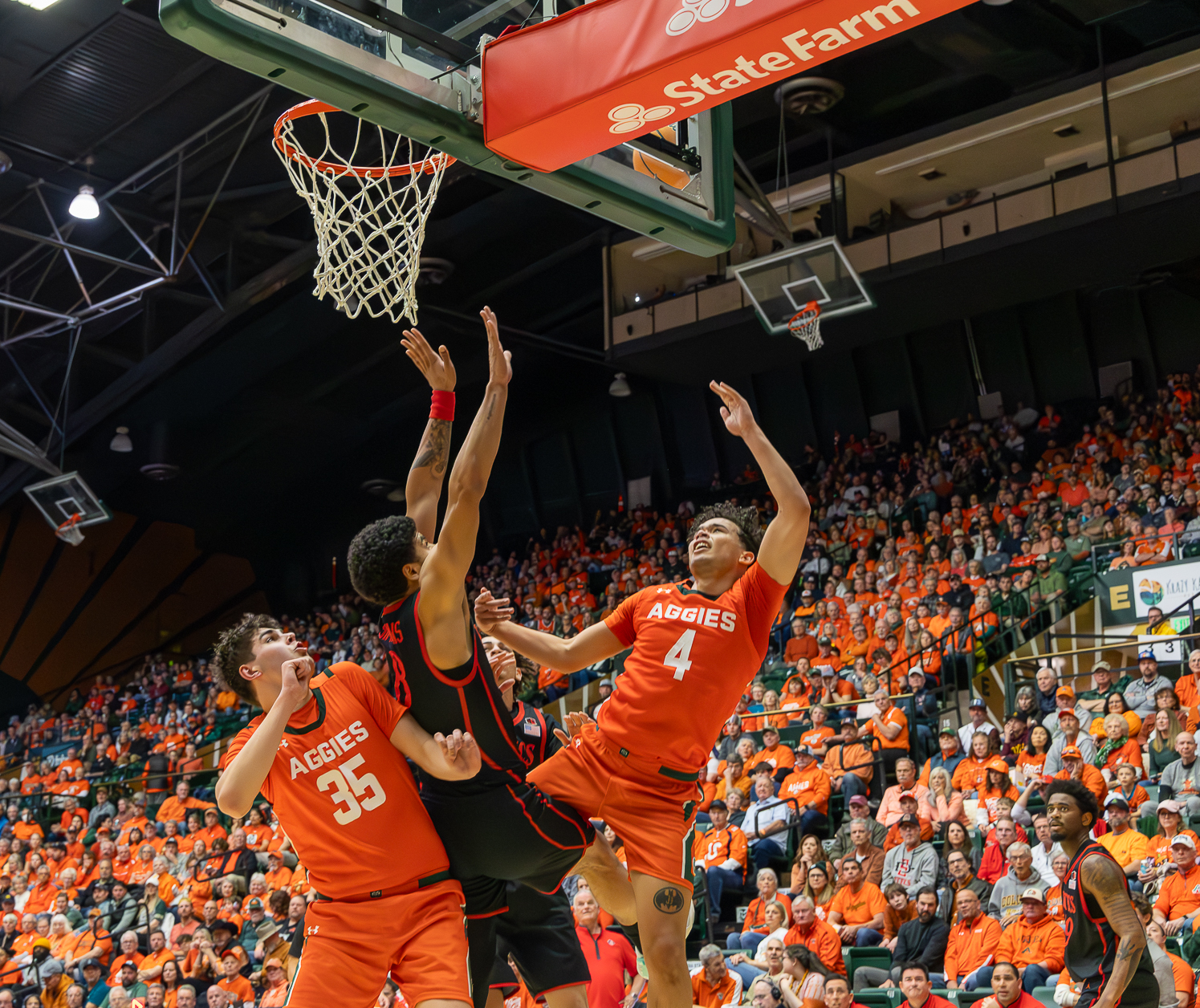 Colorado State University men's basketball guard Jase Butler (4) throws the ball hoping to score while being pressured by San Diego State University's defense Feb. 21. Butler was the highest scoring player for CSU this game, putting up 25 points.