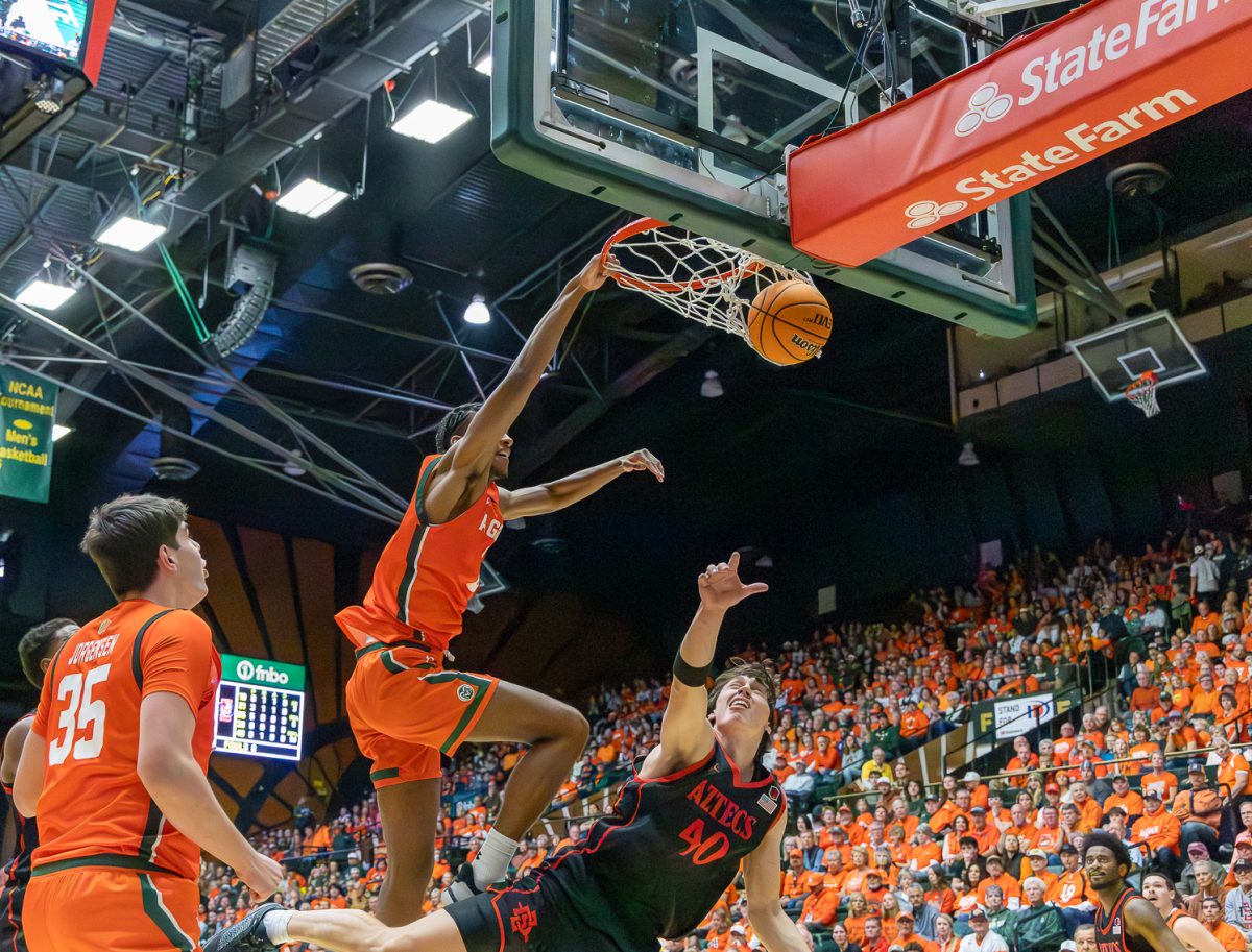 Colorado State University men's basketball forward Carey Booth (0) attacks the rim and dunks, adding momentum to CSU's rematch against San Diego State Feb. 21. The Rams won 83-74, coming back from a 73-50 loss against SDSU earlier in the season.