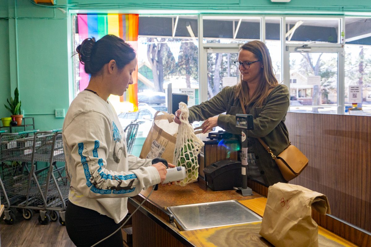 Employee Dru Miyamoto scans items for Erica Hellmich during the check out process at Fort Collins Food Co-Op Feb 22. The new location plans to add a coffee shop, a meat department, and a selection of beer and wine.