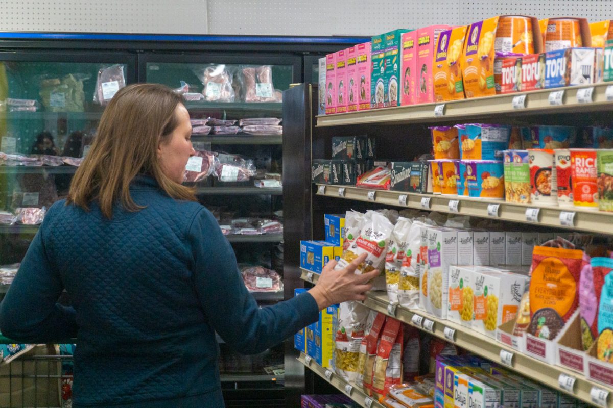 Jennifer Reichle looks at a bag of pasta in the Fort Collins Food Co-Op February 22. The shop relocated from 250 E Mountain Ave to expand the store's offerings and services.