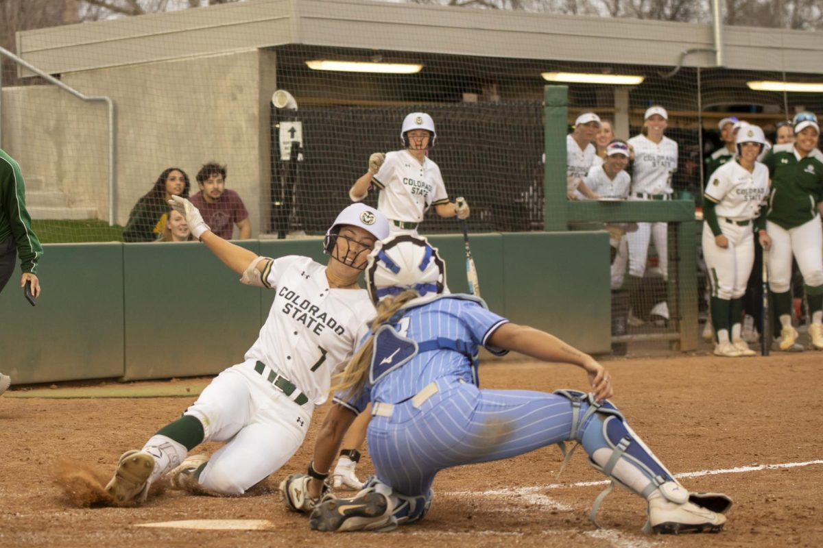 Autumn Rutherford (7) slides into home plate in an attempt to get an inside the park home run during Colorado State University's game against Creighton Feb. 28.. The Rams won 6-2 at the CSU softball field.