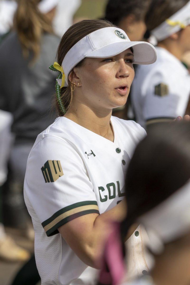CSU softball player cheers on her teamates from the dugout Pitcher Reagan Wick (12) pitches the ball during game against UNC. The Rams won 5-1 at the CSU softball field on Feb. 28.