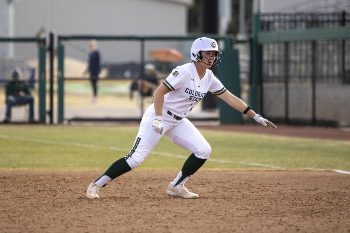 Nadia DeZeeuw (23) leads off of first base and prepares to dive back Pitcher Reagan Wick (12) pitches the ball during game against UNC. The Rams won 5-1 at the CSU softball field on Feb. 28.