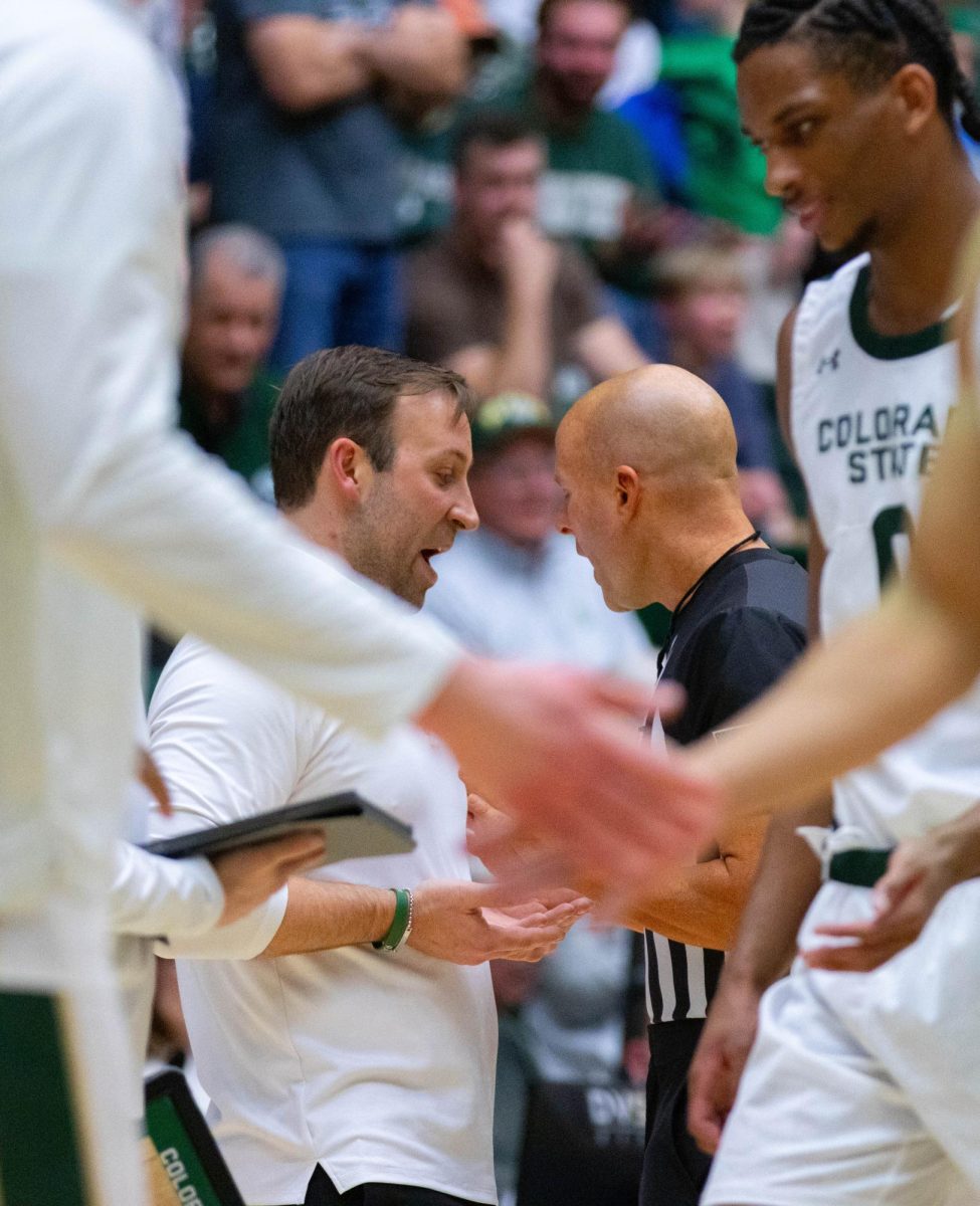 Colorado State University men's basketball coach Ali Farokhmanesh exchanges words with referee John Floyd during CSU's game against Fresno State University at Moby Arena Feb. 24. 
