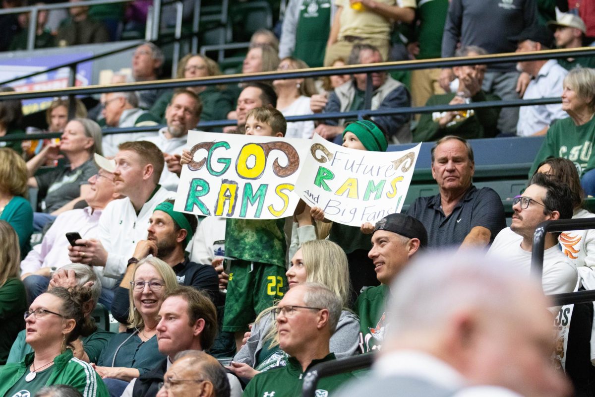 Two young kids holding up signs that say "Go Rams" and "Future Rams and Big Fans!"