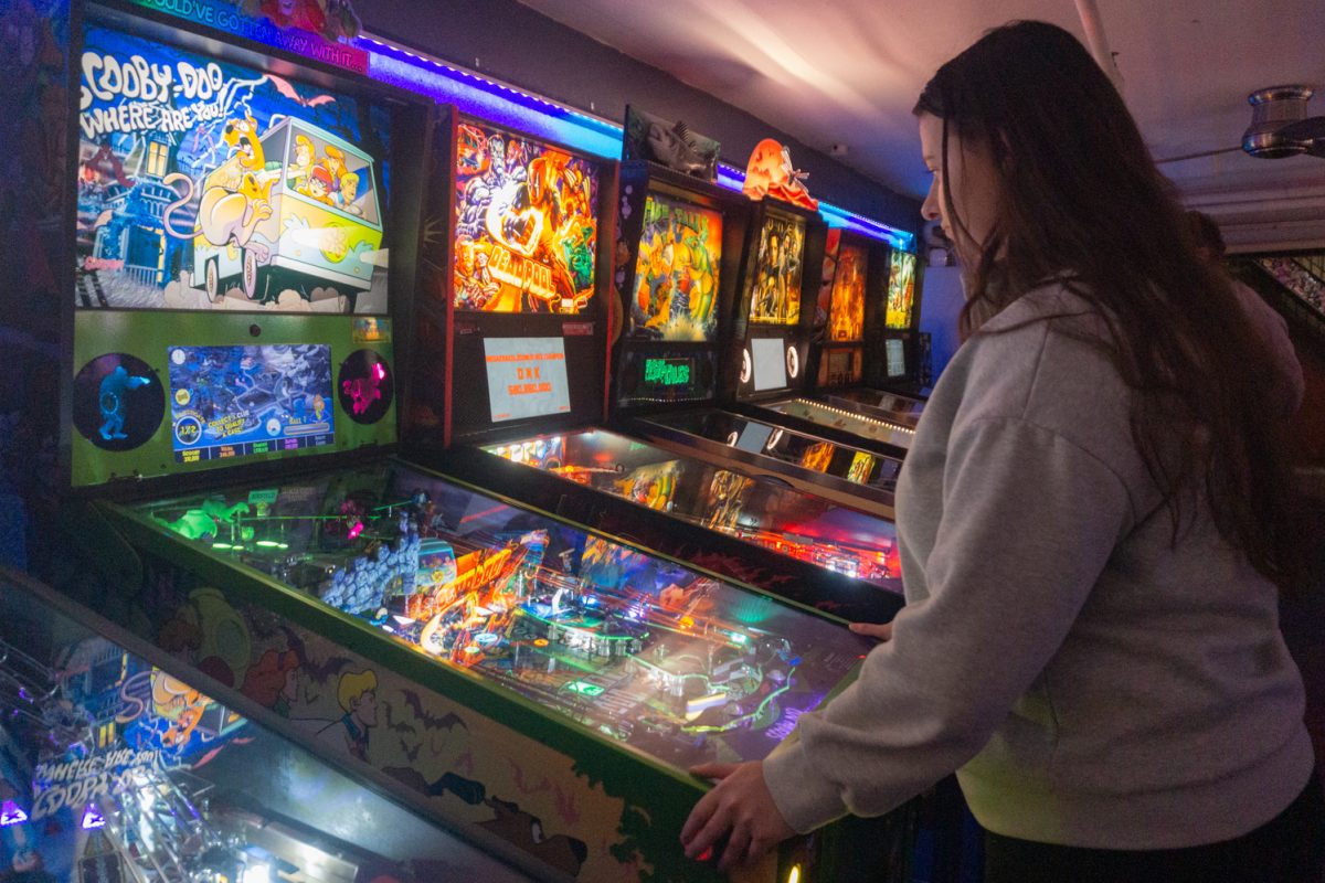 Ericka Stonebay plays a Scooby-Doo themed pinball game during the Women, Trans, Femme league at Pinball Jones Feb 12. Stonebay, who helped establish the league, said the league's goal is to create a space for women, trans, and femme-identifying players in the world of pinball, which is a male-dominated sport.
