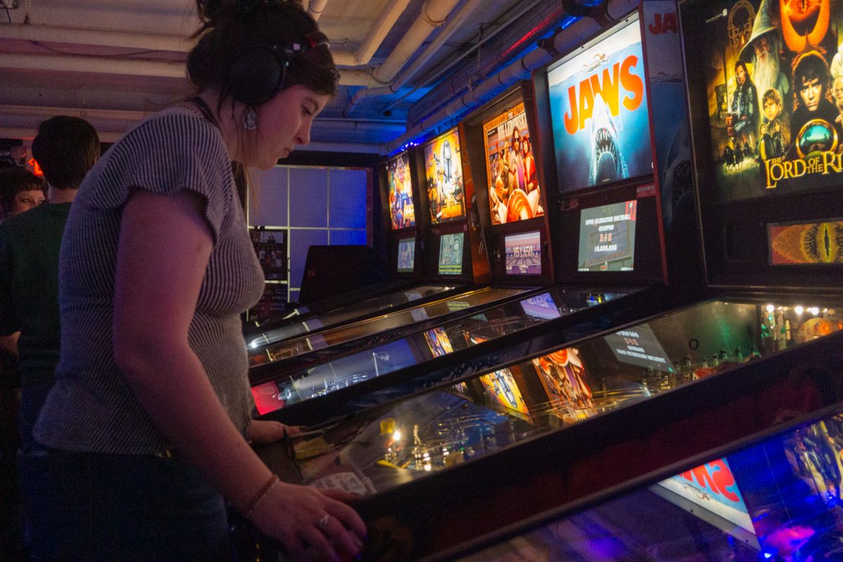 Savannah Brown plays the Lord of the Rings pinball game during the Women, Femme, Trans League at Pinball Jones February 12. The league is meant to "help players grow their skills, connect with others, and enjoy pinball in a supportive setting" according to the Pinball Jones website.