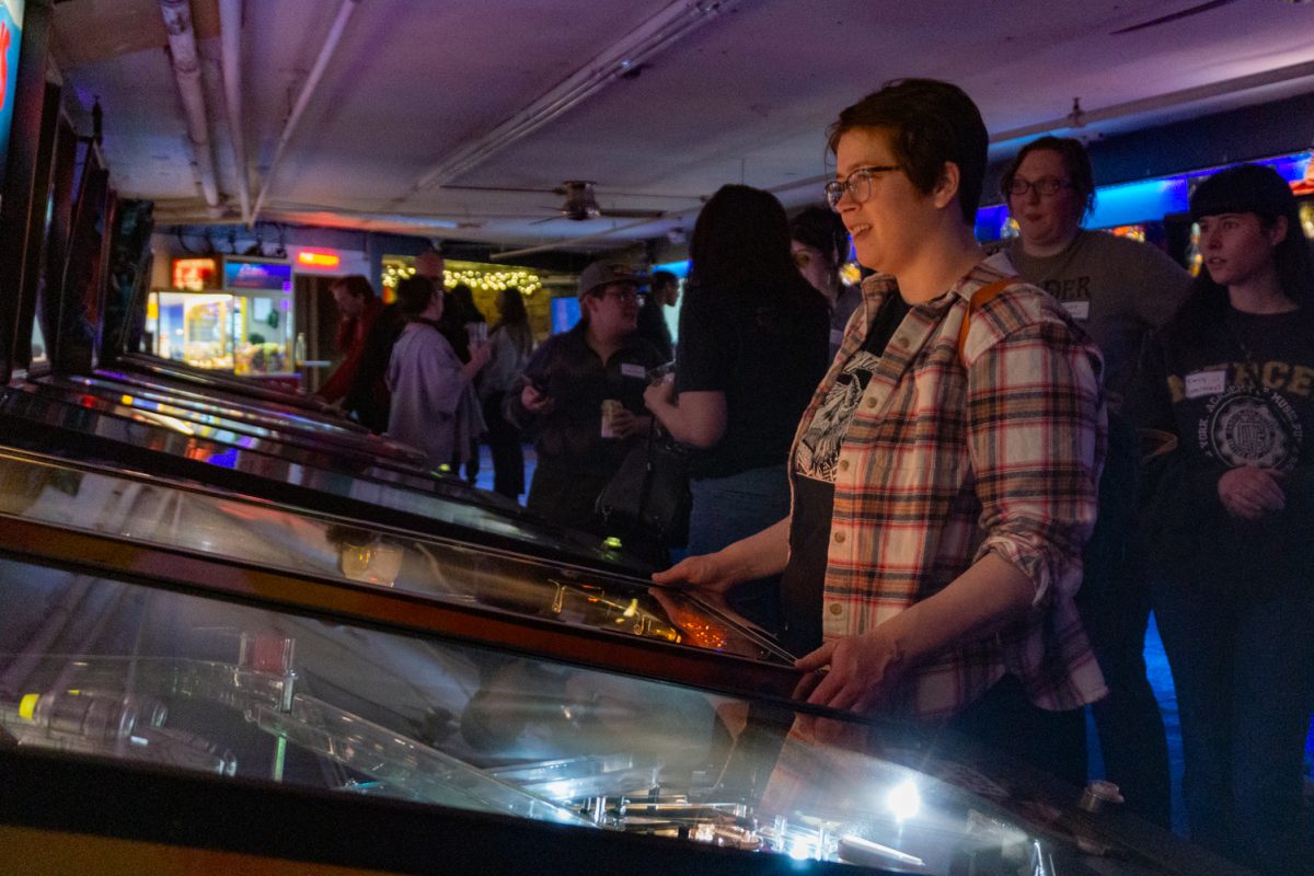 Kimberly Jordan focuses on a pinball game during the Women, Femme, Trans league at Pinball Jones Feb 12. The league is meant to "help players grow their skills, connect with others, and enjoy pinball in a supportive setting" according to the Pinball Jones website.