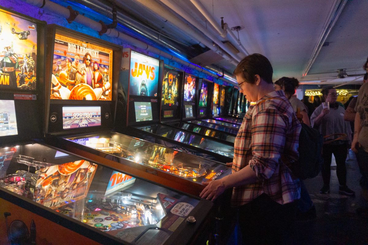 Kimberly Jordan focuses on a pinball game during the Women, Femme, Trans league at Pinball Jones Feb 12. The league is meant to "help players grow their skills, connect with others, and enjoy pinball in a supportive setting" according to the Pinball Jones website.
