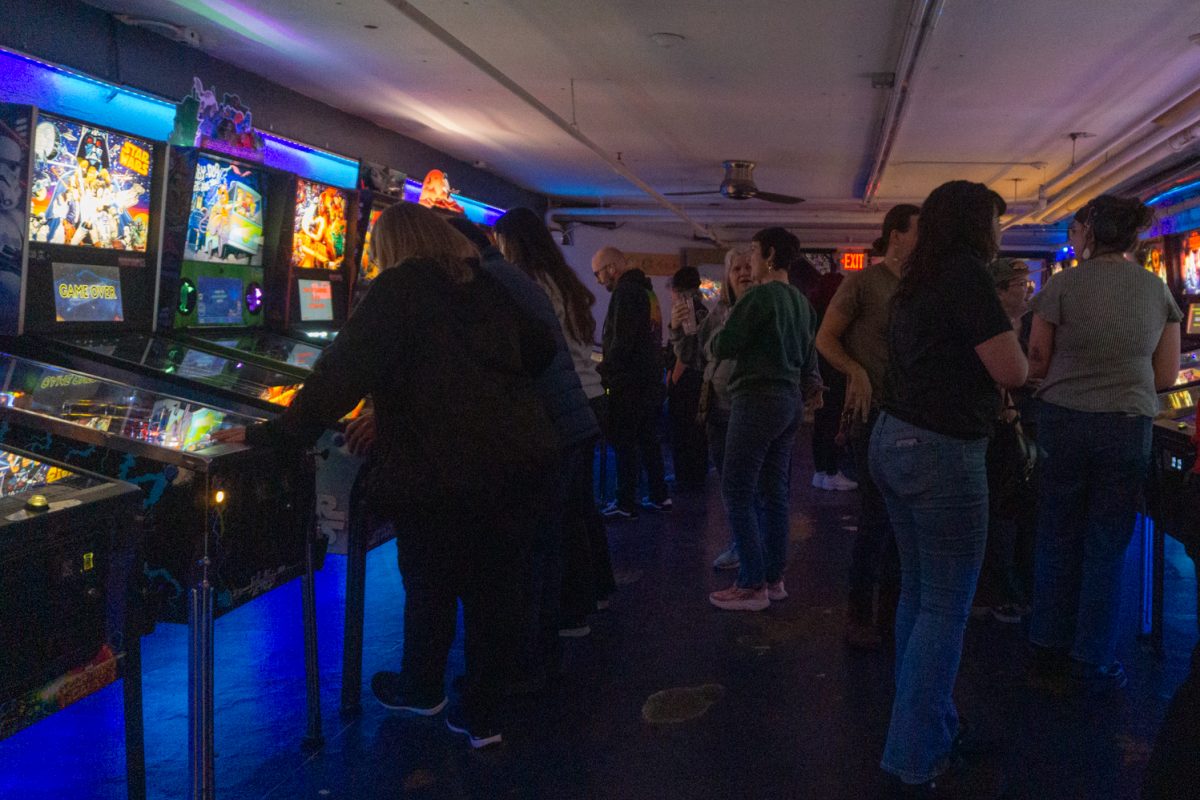 Participants play and wait their turn during the Women, Femme, Trans league at Pinball Jones Feb 12. Ericka Stonebay, who helped establish the league, said the league's goal is to create a space for women, trans, and femme-identifying players in the world of pinball, which is a male-dominated sport.