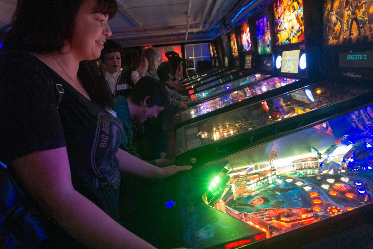 Andrea Exendine plays a pinball machine during the Women, Trans, Femme league at Pinball Jones Feb 12. The league is meant to "help players grow their skills, connect with others, and enjoy pinball in a supportive setting" according to the Pinball Jones website.