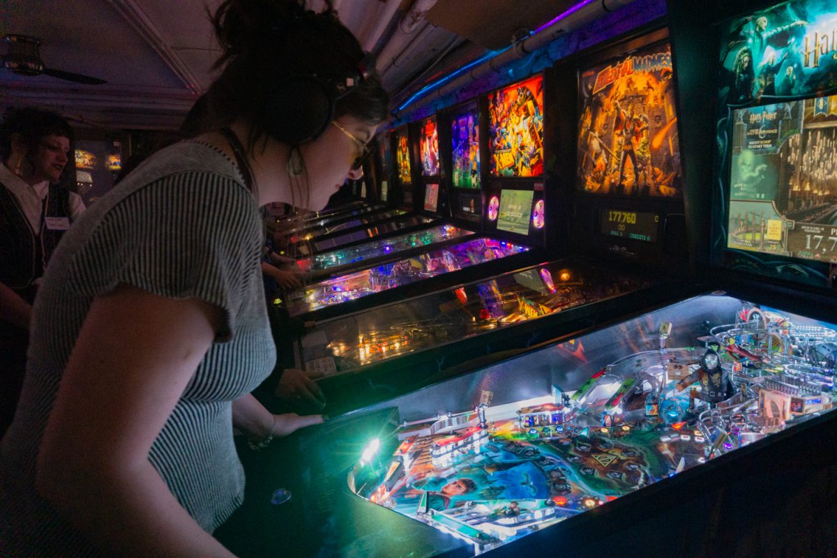 Savannah Brown plays the Harry Potter pinball game during the Women, Femme, Trans League at Pinball Jones February 12. Ericka Stonebay, who helped establish the league, said the league's goal is to create a space for women, trans, and femme-identifying players in the world of pinball, which is a male-dominated sport.