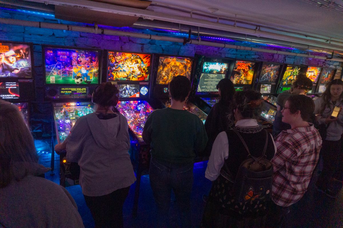 Participants wait their turn to play during the Women, Femme, Trans league at Pinball Jones Feb 12.The league is meant to "help players grow their skills, connect with others, and enjoy pinball in a supportive setting" according to the Pinball Jones website.