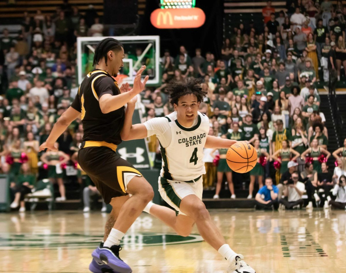 Colorado State University men's basketball guard Jase Butler (4) dribbles past a defender from the University of Wyoming in CSU's home game against UW Feb. 14. CSU won 79-68 against UW after losing 68-57 in Laramie, Wyoming, earlier in the season. 