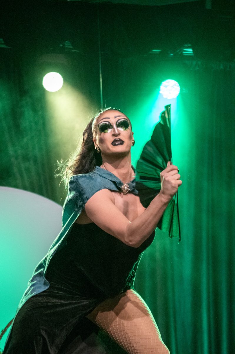 Queen Ambersand waves a fan during her performance at the annual Colorado State University Drag Show March 29.