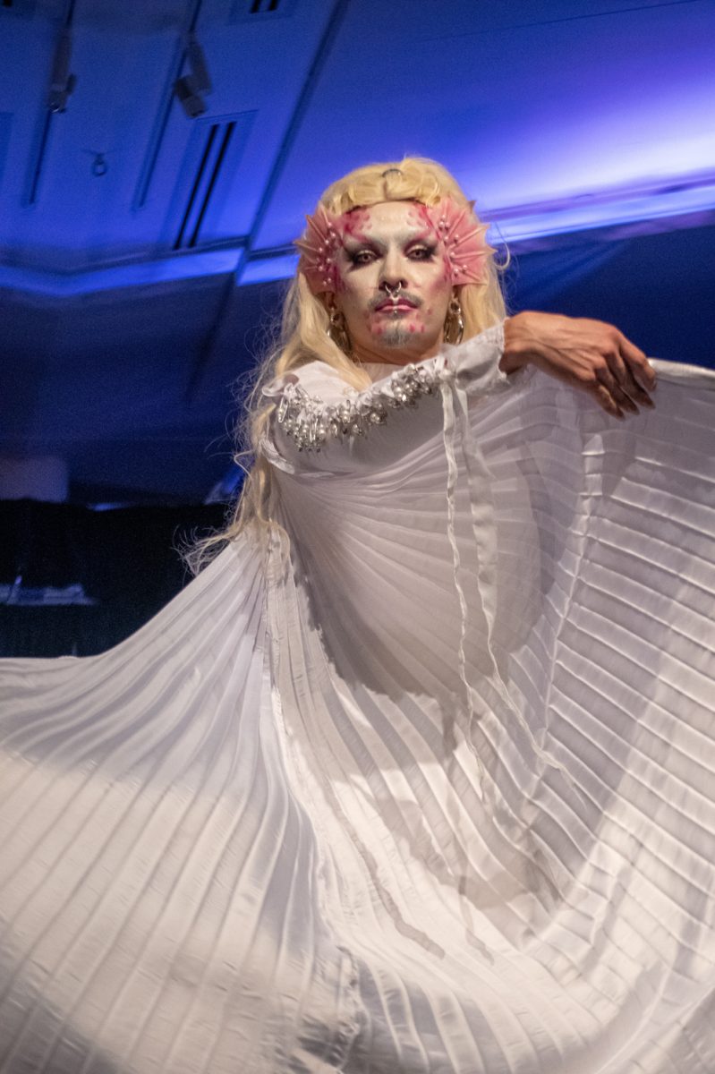 Tooth Decay waves her wings to the crowd during the final bow at the annual Colorado State University Drag Show March 29. 
