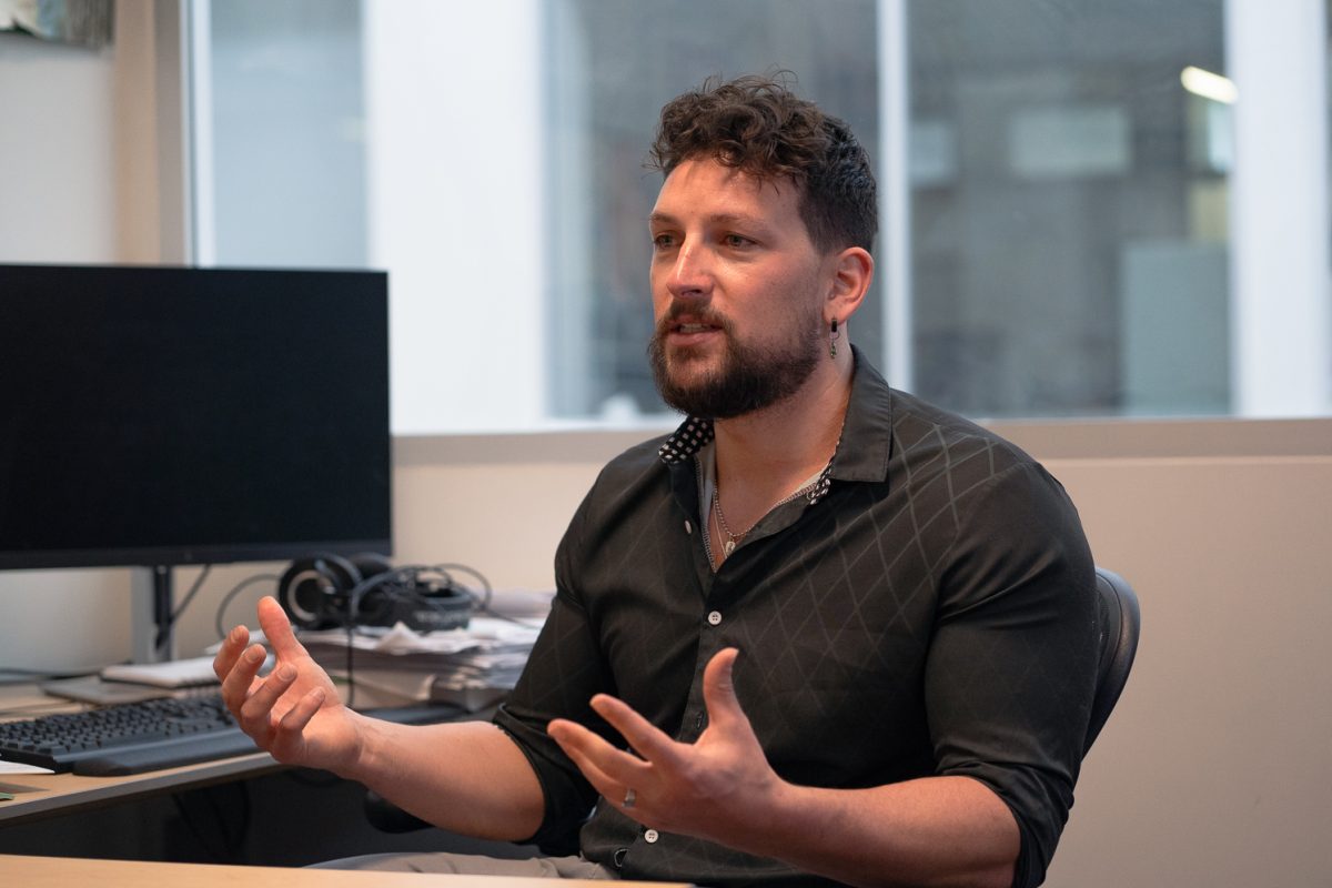 Colorado State University Assistant Professor of Psychology Keaton Fletcher explains his research focus in his office Wednesday, Feb. 25. Fletcher studies organizational psychology and focuses on leadership, occupational health and teams.  