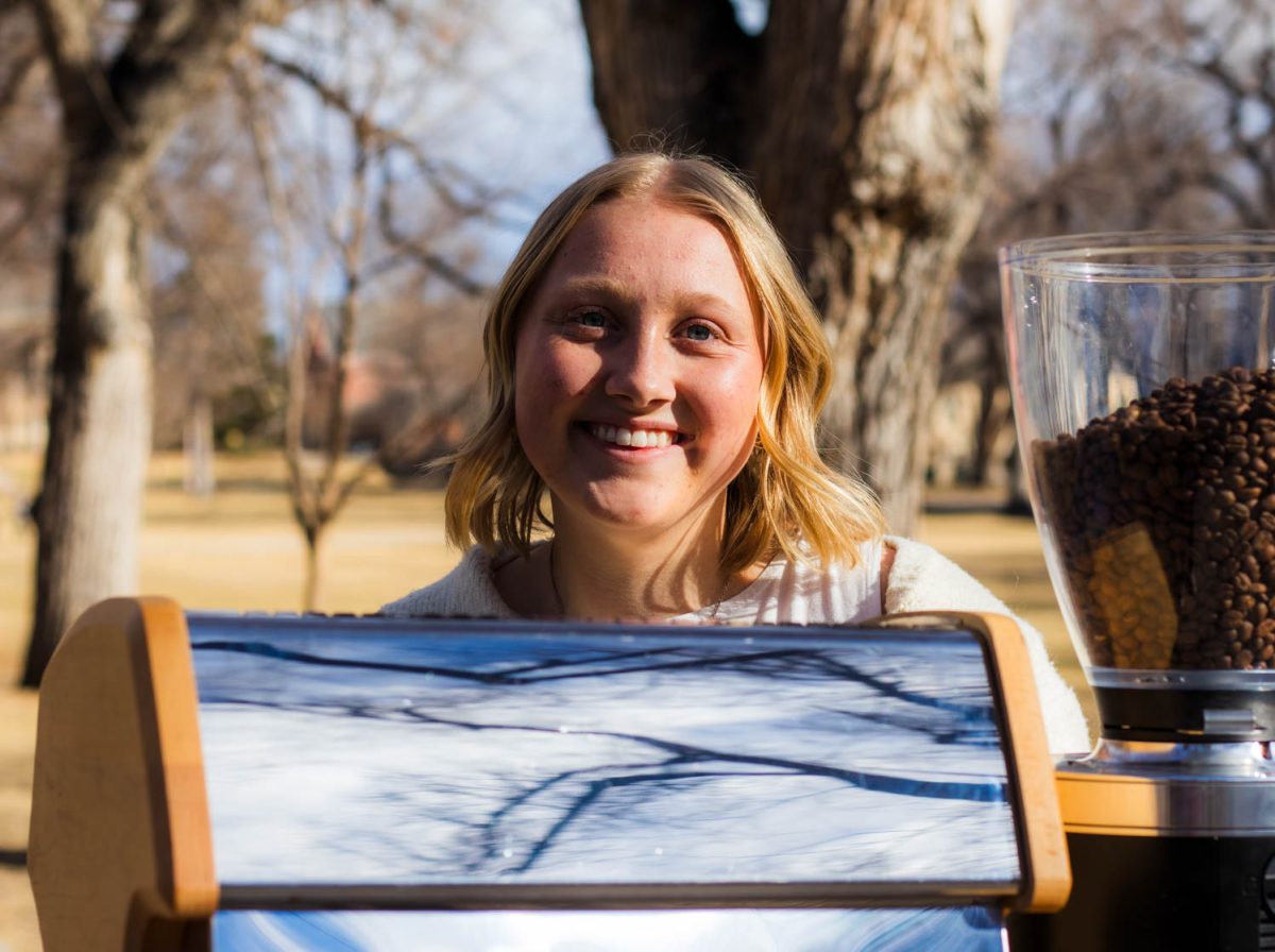 Ellinor Davis stands with her Happenstance Coffee cart on the Oval at Colorado State University, Feb. 25. “The goal in the future is to have a brick and mortar and keep doing the cart for catering stuff, just keep building over the years, which would be awesome,” she said.