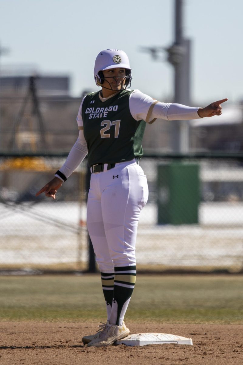 Clarissa Castillo (21) stands on second and points during Colorado State University’s first game against University of South Dakota March 7. The Rams won 4-2 at the CSU softball field.