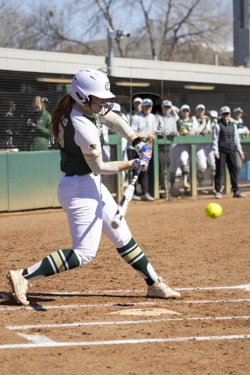 Madi Eslinger (13) hits the ball during Colorado State University’s first game against University of South Dakota March 7. The Rams won 4-2 at the CSU softball field.