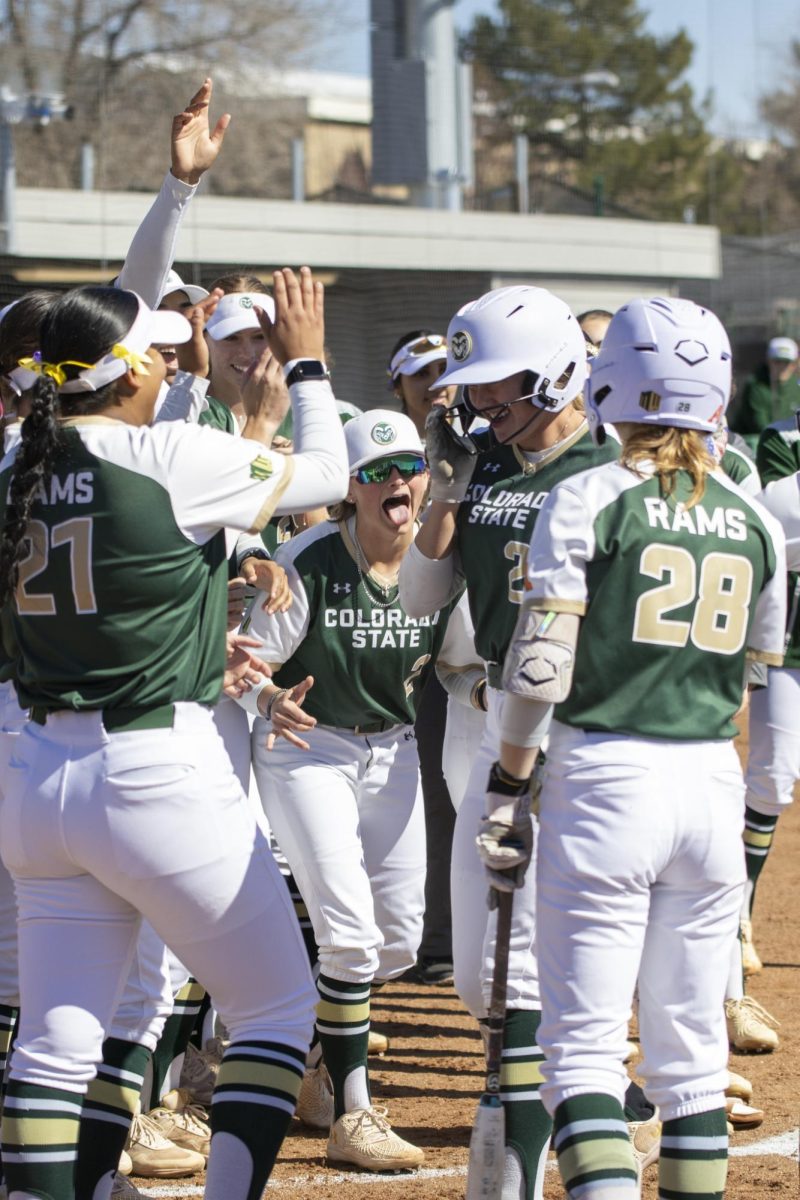 The Rams congratulate teamate's home run during Colorado State University’s first game against University of South Dakota March 7. The Rams won 4-2 at the CSU softball field.