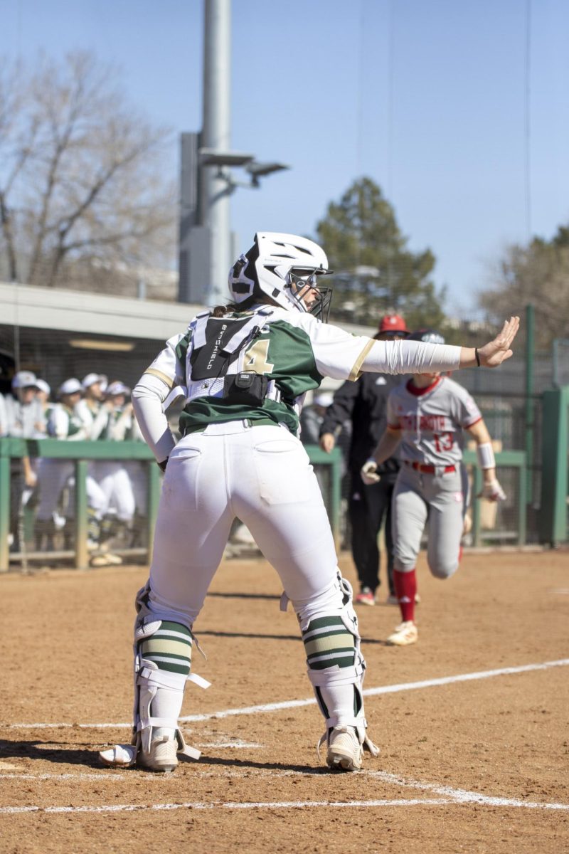 Abby Edwards (34) commands temates to hold the ball and not throw home during Colorado State University’s first game against University of South Dakota March 7. The Rams won 4-2 at the CSU softball field.