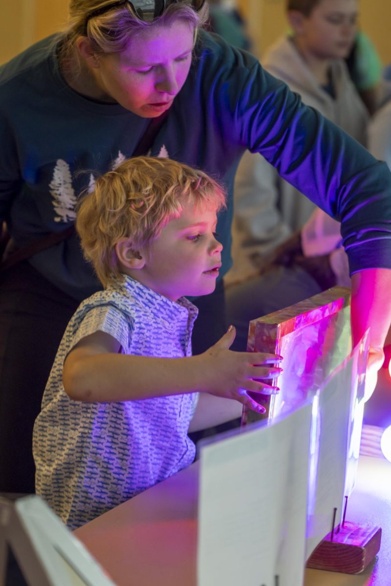 [Guardian gave permission, last name omitted] Jackson explores the properties of light and color during the Little Shop of Physics 32nd Open House at the LSC March 1st.