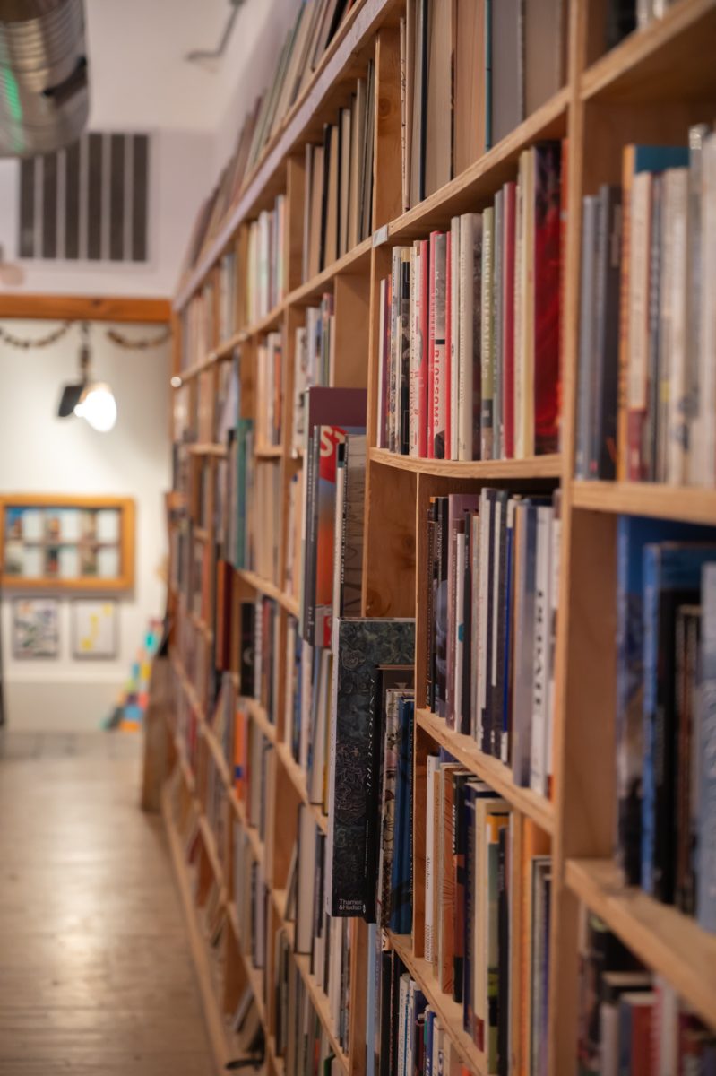 A wall of faded poetry books marks the entrance to the room where the Gulo Gulo Poetry Collectives hosts their evening event Mar. 3. Every first Tuesday of the month the poetry collective hosts a writing workshop where people come to be inspired by the prompts of the night.