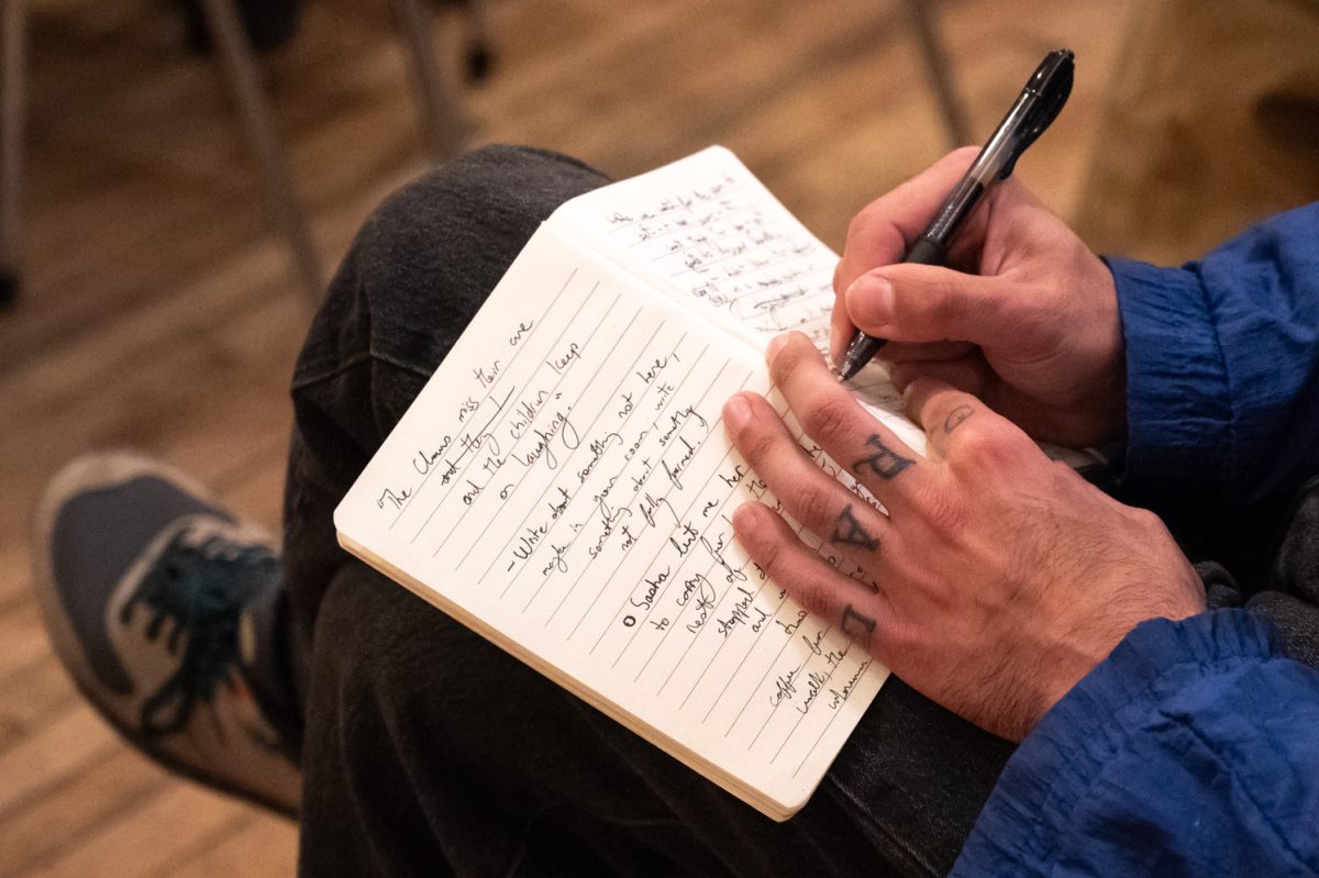 Alex Dolabi, a newer member to join the poetry collective, writes out a response to one of the event’s prompts Mar. 3. “I think one of the many things you have to do together as a community is kind of come up with new ways and new languages, a kind of poesis,” Dolabi said. “I really only produce best just when I’m around people.”
