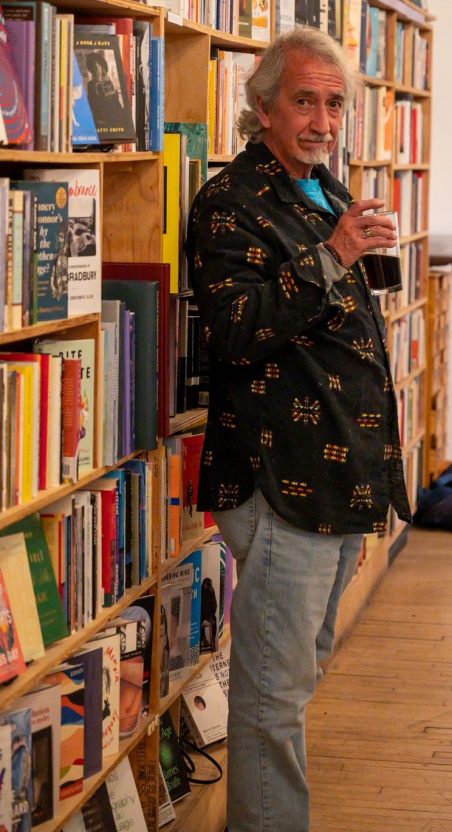 Larry “Booger” Holgerson, who many of the participants describe as the Collective’s leader in all but name, watches as people gather together to discuss and work on the poetry Mar. 3. Not just a member of the poetry collective, Holgerson also leads the slam poetry night at the Lyric. “The young people and the young minds are incredible here,” Holgerson said. “To see the way they reflect upon it is a joy to me, to see how and what they have to say about the world.”