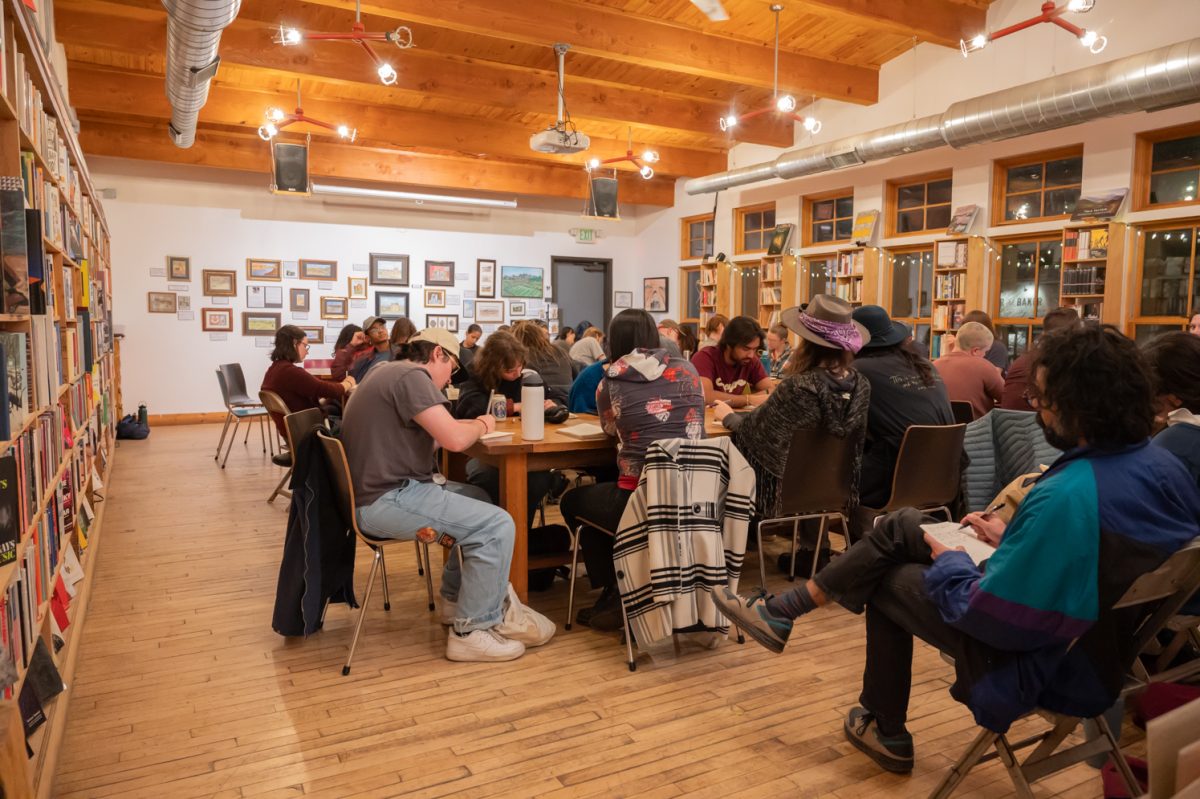 As a group the Gulo Gulo Poetry Collective writes in quiet contemplation Mar. 3. They sit and consider their responses to the prompts provided by the evening's facilitator, such as what nostalgia feels like or how certain emotions can be personified.