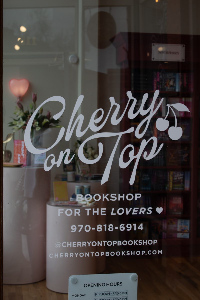 The front door of Cherry On Top bookshop displays its logo and slogan, in Downtown Fort Collins Mar. 5. This romance-only book store, Fort Collins’ first, had its grand opening on February 13th of this year. “We are working on getting events going, so we’re gonna have, like, community events and we’ve had lots of requests for book clubs,” co-owner Meredith Glover said.