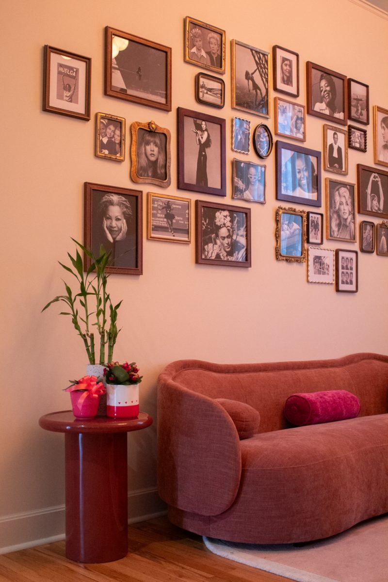A reading nook inside Cherry On Top, a romance-only bookshop in Downtown Fort Collins, features couches, a display table, and a collage of authors, Mar. 5. The bookstore  is co-owned and run by Meredith Glover and Devon Beuret - friends, neigbors, and Fort Collins locals.  It opened on February 13th of this year. The date was on theme - “Galentines day!” co-owner Meredith Glover said.