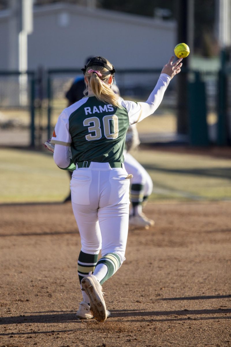 Andrea Jaskowiak (30) throws to first during Colorado State University’s second game against University of South Dakota March 7. The Rams lost 2-6 at the CSU softball field.